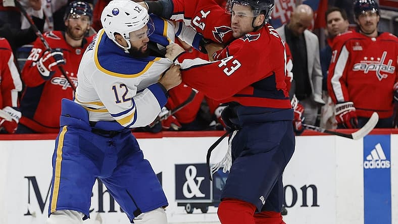 Nov 22, 2023; Washington, District of Columbia, USA; Washington Capitals right wing Tom Wilson (43) fights Buffalo Sabres left wing Jordan Greenway (12) in the first period at Capital One Arena. Mandatory Credit: Geoff Burke-USA TODAY Sports