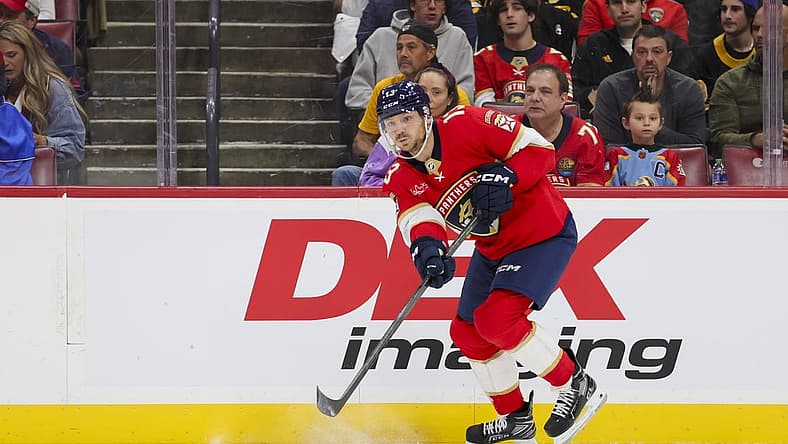 Nov 22, 2023; Sunrise, Florida, USA; Florida Panthers center Sam Reinhart (13) passes the puck against the Boston Bruins during the first period at Amerant Bank Arena. Mandatory Credit: Sam Navarro-USA TODAY Sports