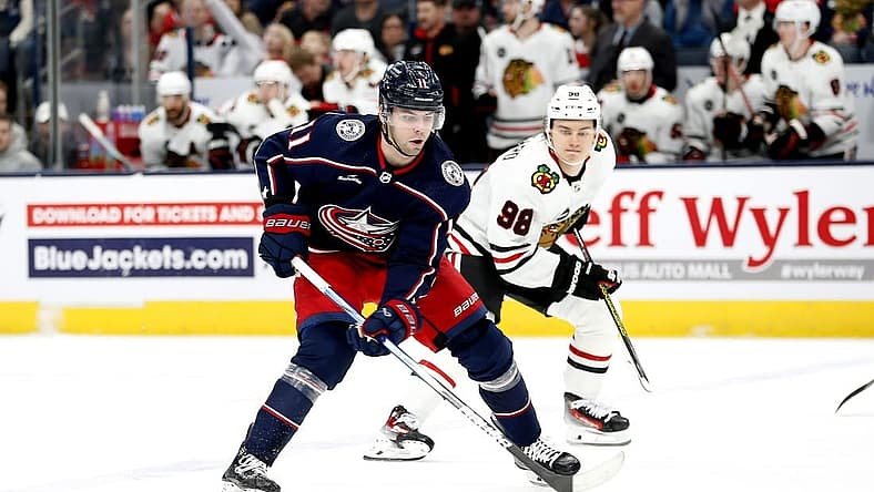 Nov 22, 2023; Columbus, Ohio, USA; Columbus Blue Jackets center Adam Fantilli (11) shoots the puck as Chicago Blackhawks center Connor Bedard (98) trails the play during the first period at Nationwide Arena. Mandatory Credit: Russell LaBounty-USA TODAY Sports