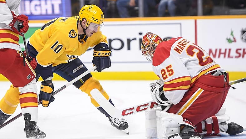 Nov 22, 2023; Nashville, Tennessee, USA; Calgary Flames goaltender Jacob Markstrom (25) blocks the shot of Nashville Predators center Colton Sissons (10) during the first period at Bridgestone Arena. Mandatory Credit: Steve Roberts-USA TODAY Sports