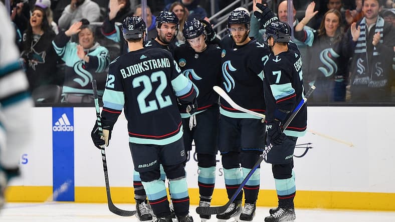 Nov 22, 2023; Seattle, Washington, USA; The Seattle Kraken celebrate after a goal scored by left wing Jared McCann (19) during the second period against the San Jose Sharks at Climate Pledge Arena. Mandatory Credit: Steven Bisig-USA TODAY Sports