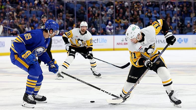 Nov 24, 2023; Buffalo, New York, USA;  Buffalo Sabres right wing Alex Tuch (89) and Pittsburgh Penguins left wing Alex Nylander (11) go after a loose puck during the first period at KeyBank Center. Mandatory Credit: Timothy T. Ludwig-USA TODAY Sports