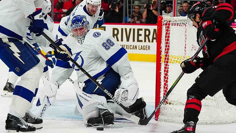 Nov 24, 2023; Raleigh, North Carolina, USA; Tampa Bay Lightning goaltender Andrei Vasilevskiy (88) stops the scoring attempt by Carolina Hurricanes center Seth Jarvis (24) during the first period at PNC Arena. Mandatory Credit: James Guillory-USA TODAY Sports