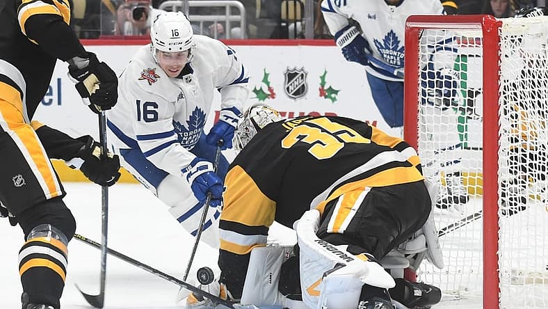Nov 25, 2023; Pittsburgh, Pennsylvania, USA; Pittsburgh Penguins goalie Tristan Jarry (35) stops Toronto Maple Leafs right wing Mitchell Marner (16) during the second period at PPG Paints Arena. Mandatory Credit: Philip G. Pavely-USA TODAY Sports
