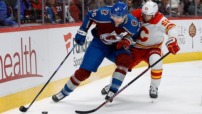 Nov 25, 2023; Denver, Colorado, USA; Colorado Avalanche right wing Mikko Rantanen (96) and Calgary Flames defenseman MacKenzie Weegar (52) battle for the puck in the first period at Ball Arena. Mandatory Credit: Isaiah J. Downing-USA TODAY Sports