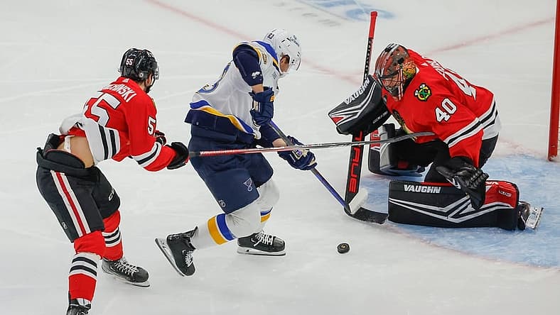 Nov 26, 2023; Chicago, Illinois, USA; St. Louis Blues left wing Jake Neighbours (63) attempts to score against Chicago Blackhawks goaltender Arvid Soderblom (40) during the first period at United Center. Mandatory Credit: Kamil Krzaczynski-USA TODAY Sports