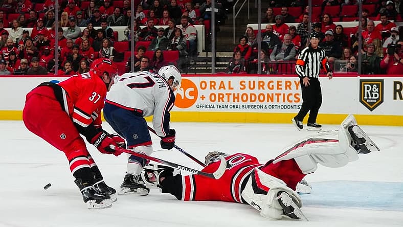 Nov 26, 2023; Raleigh, North Carolina, USA; Carolina Hurricanes goaltender Pyotr Kochetkov (52) and right wing Andrei Svechnikov (37) stop the scoring attempt by Columbus Blue Jackets right wing Justin Danforth (17) during the second period at PNC Arena. Mandatory Credit: James Guillory-USA TODAY Sports