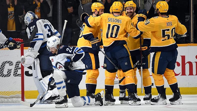 Nov 26, 2023; Nashville, Tennessee, USA; Nashville Predators players celebrate a goal by left wing Gustav Nyquist (14) during the second period against the Winnipeg Jets at Bridgestone Arena. Mandatory Credit: Christopher Hanewinckel-USA TODAY Sports