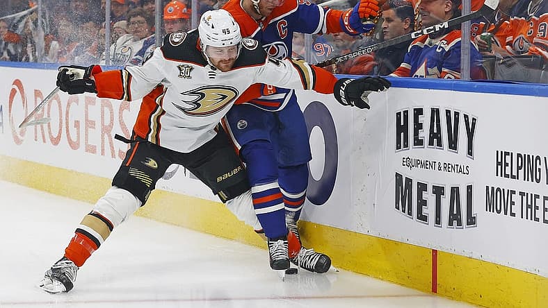 Nov 26, 2023; Edmonton, Alberta, CAN; Anaheim Ducks forward Max Jones (49) and Edmonton Oilers forward Connor McDavid (97) battle along the boards for a loose puck during the first period at Rogers Place. Mandatory Credit: Perry Nelson-USA TODAY Sports