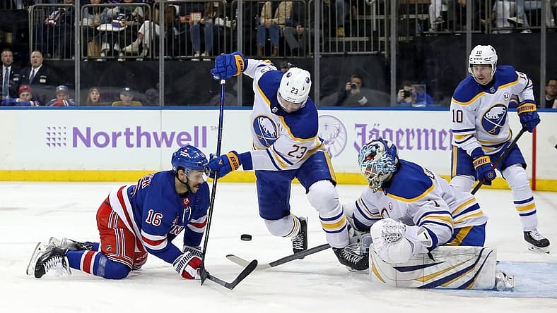 Nov 27, 2023; New York, New York, USA; Buffalo Sabres goalie Ukko-Pekka Luukkonen (1) makes a save as New York Rangers center Vincent Trocheck (16) and Buffalo Sabres defenseman Mattias Samuelsson (23) battle for the puck during the second period at Madison Square Garden. Mandatory Credit: Danny Wild-USA TODAY Sports