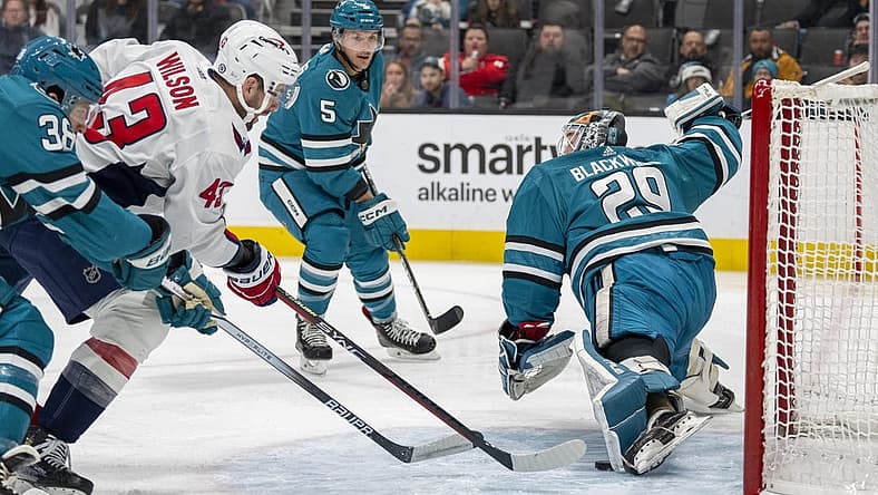 Nov 27, 2023; San Jose, California, USA; San Jose Sharks goaltender Mackenzie Blackwood (29) makes a leg save against Washington Capitals right wing Tom Wilson (43) during the first period at SAP Center at San Jose. Mandatory Credit: Neville E. Guard-USA TODAY Sports