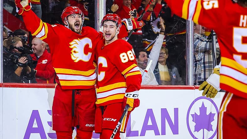 Nov 27, 2023; Calgary, Alberta, CAN; Calgary Flames defenseman MacKenzie Weegar (52) celebrates his goal against the Vegas Golden Knights during the overtime period at Scotiabank Saddledome. Mandatory Credit: Sergei Belski-USA TODAY Sports
