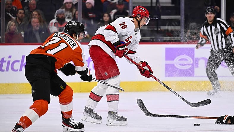 Nov 28, 2023; Philadelphia, Pennsylvania, USA; Carolina Hurricanes center Sebastian Aho (20) reaches for the puck against Philadelphia Flyers right wing Tyson Foerster (71) in the first period at Wells Fargo Center. Mandatory Credit: Kyle Ross-USA TODAY Sports