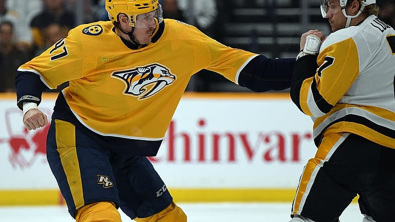 Nov 28, 2023; Nashville, Tennessee, USA; Nashville Predators right wing Michael McCarron (47) and Pittsburgh Penguins defense John Ludvig (7) exchange hits in a fight during the second period at Bridgestone Arena. Mandatory Credit: Christopher Hanewinckel-USA TODAY Sports