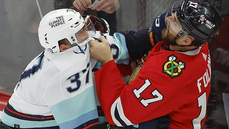 Nov 28, 2023; Chicago, Illinois, USA; Seattle Kraken center Yanni Gourde (37) fights with Chicago Blackhawks left wing Nick Foligno (17) during the second period at United Center. Mandatory Credit: Kamil Krzaczynski-USA TODAY Sports