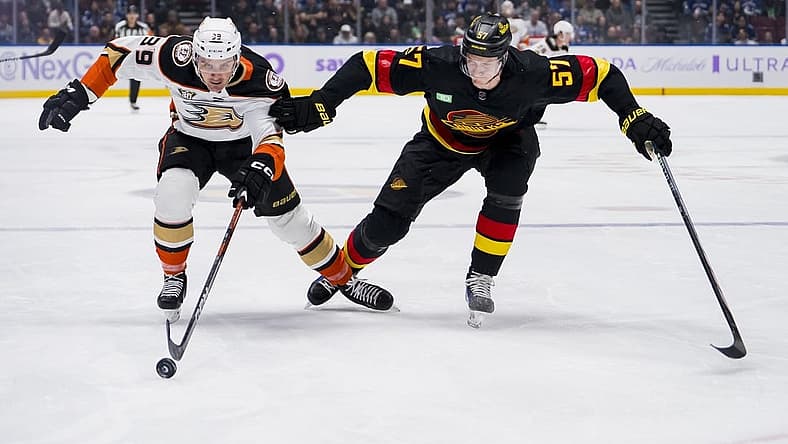 Nov 28, 2023; Vancouver, British Columbia, CAN; Vancouver Canucks defenseman Tyler Myers (57) battles with Anaheim Ducks forward Sam Carrick (39) in the first period at Rogers Arena. Mandatory Credit: Bob Frid-USA TODAY Sports