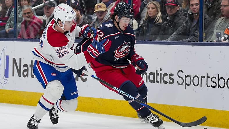 Nov 29, 2023; Columbus, Ohio, USA; Columbus Blue Jackets center Alexandre Texier (42) skates with the puck against Montreal Canadiens defenseman Justin Barron (52) in the second period at Nationwide Arena. Mandatory Credit: Aaron Doster-USA TODAY Sports