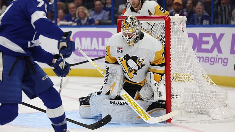 Nov 30, 2023; Tampa, Florida, USA; Pittsburgh Penguins goaltender Tristan Jarry (35) makes save from Tampa Bay Lightning center Anthony Cirelli (71) during the first period at Amalie Arena. Mandatory Credit: Kim Klement Neitzel-USA TODAY Sports