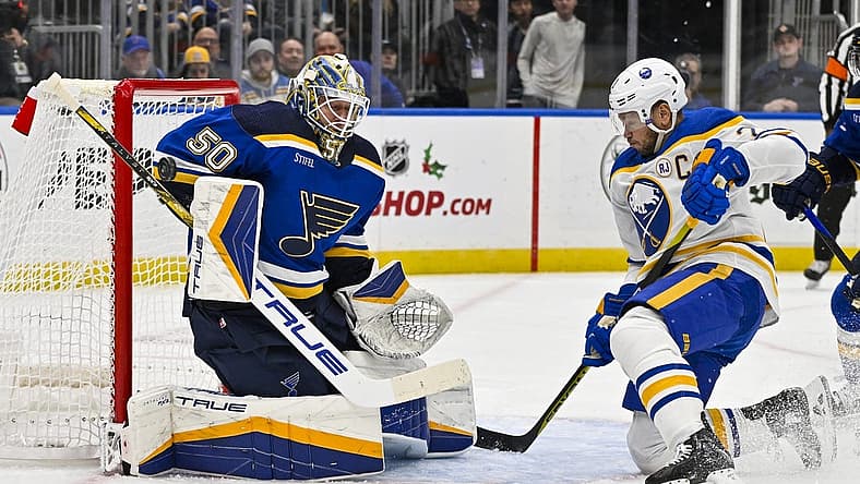 Nov 30, 2023; St. Louis, Missouri, USA; St. Louis Blues goaltender Jordan Binnington (50) makes a save against Buffalo Sabres right wing Kyle Okposo (21) during the first period at Enterprise Center. Mandatory Credit: Jeff Curry-USA TODAY Sports