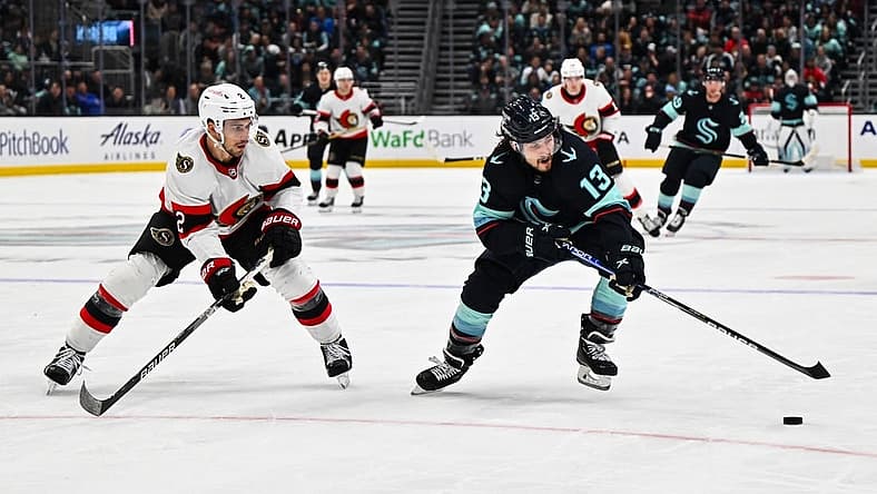 Mar 9, 2023; Seattle, Washington, USA; Seattle Kraken left wing Brandon Tanev (13) plays the puck while being defended by Ottawa Senators defenseman Artem Zub (2) during the third period at Climate Pledge Arena. Ottawa defeated Seattle 5-4. Mandatory Credit: Steven Bisig-USA TODAY Sports