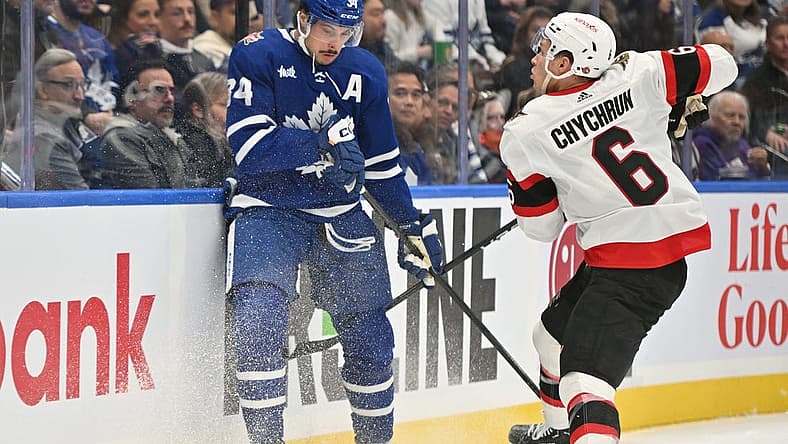Nov 8, 2023; Toronto, Ontario, CAN; Ottawa Senators defenseman Jakob Chychrun (6) bodychecks Toronto Maple Leafs forward Auston Matthews (34) in the first period at Scotiabank Arena. Mandatory Credit: Dan Hamilton-USA TODAY Sports
