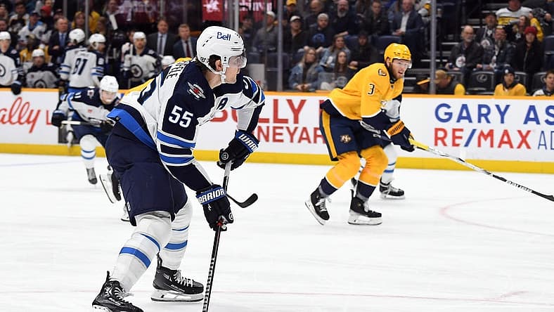 Nov 26, 2023; Nashville, Tennessee, USA; Winnipeg Jets center Mark Scheifele (55) shoots the puck during the second period against the Nashville Predators at Bridgestone Arena. Mandatory Credit: Christopher Hanewinckel-USA TODAY Sports