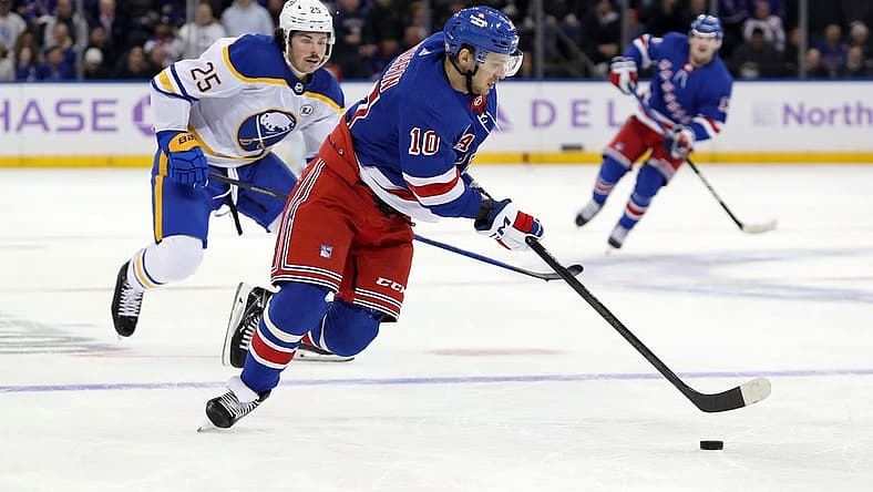 Nov 27, 2023; New York, New York, USA; New York Rangers left wing Artemi Panarin (10) skates with the puck in front of Buffalo Sabres defenseman Owen Power (25) during the second period at Madison Square Garden. Mandatory Credit: Danny Wild-USA TODAY Sports