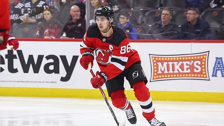 Nov 28, 2023; Newark, New Jersey, USA; New Jersey Devils center Jack Hughes (86) skates with the puck against the New York Islanders during the first period at Prudential Center. Mandatory Credit: Ed Mulholland-USA TODAY Sports