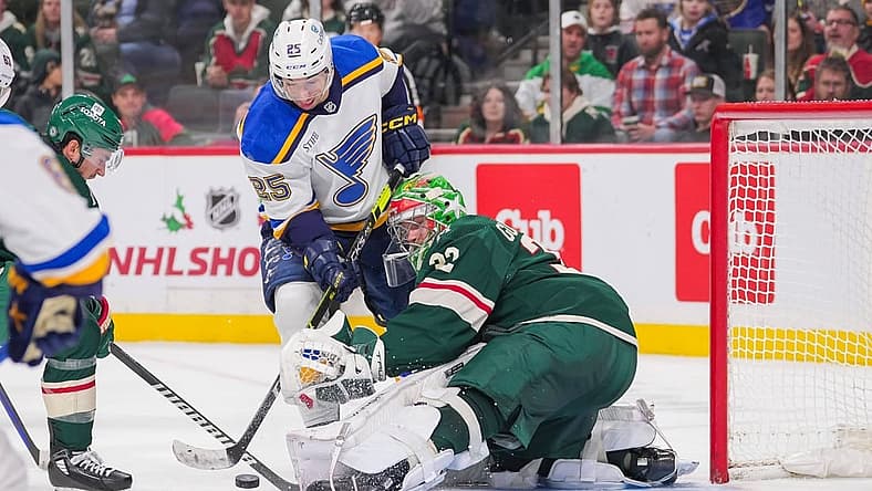 Nov 28, 2023; Saint Paul, Minnesota, USA; St. Louis Blues center Jordan Kyrou (25) shoots against the Minnesota Wild goaltender Filip Gustavsson (32) in the third period at Xcel Energy Center. Mandatory Credit: Brad Rempel-USA TODAY Sports