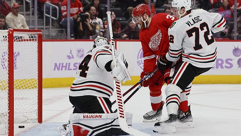 Nov 30, 2023; Detroit, Michigan, USA; Detroit Red Wings left wing J.T. Compher (37) scores a goal on Chicago Blackhawks goaltender Petr Mrazek (34) in the second period at Little Caesars Arena. Mandatory Credit: Rick Osentoski-USA TODAY Sports