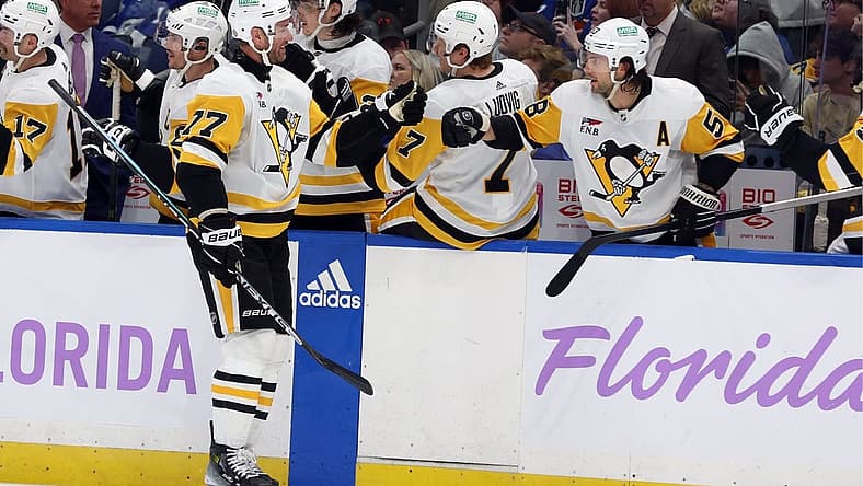 Nov 30, 2023; Tampa, Florida, USA; Pittsburgh Penguins center Jeff Carter (77) is congratulated after he scored a goal against the Tampa Bay Lightning during the third period at Amalie Arena. Mandatory Credit: Kim Klement Neitzel-USA TODAY Sports