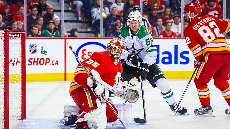 Nov 30, 2023; Calgary, Alberta, CAN; Calgary Flames goaltender Jacob Markstrom (25) makes a save against Dallas Stars right wing Evgenii Dadonov (63) during the first period at Scotiabank Saddledome. Mandatory Credit: Sergei Belski-USA TODAY Sports