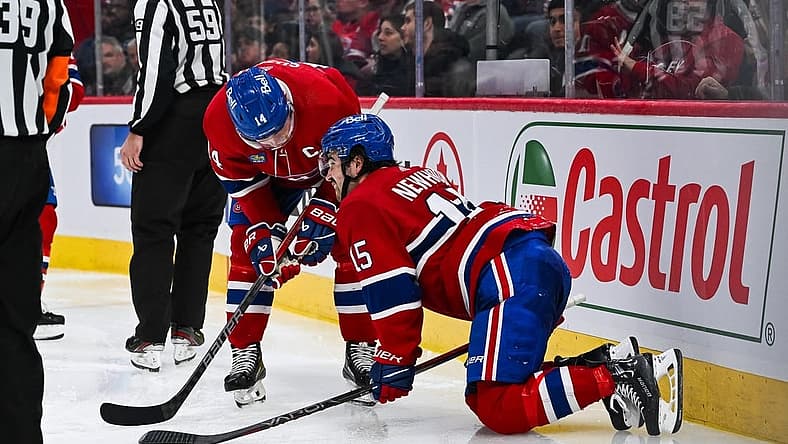Nov 30, 2023; Montreal, Quebec, CAN; Montreal Canadiens center Alex Newhook (15) gets injured on a play against the Florida Panthers during the third period at Bell Centre. Mandatory Credit: David Kirouac-USA TODAY Sports
