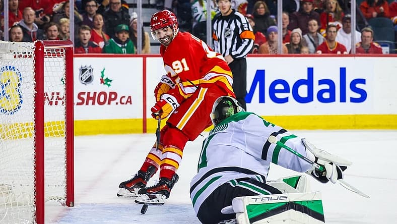 Nov 30, 2023; Calgary, Alberta, CAN; Calgary Flames center Nazem Kadri (91) scores a goal against Dallas Stars goaltender Scott Wedgewood (41) during the overtime period at Scotiabank Saddledome. Mandatory Credit: Sergei Belski-USA TODAY Sports