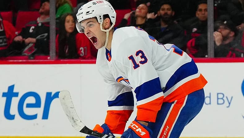 Nov 30, 2023; Raleigh, North Carolina, USA; New York Islanders center Mathew Barzal (13) celebrates his overtime winning goal against the Carolina Hurricanes at PNC Arena. Mandatory Credit: James Guillory-USA TODAY Sports