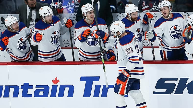 Nov 30, 2023; Winnipeg, Manitoba, CAN; Edmonton Oilers forward Leon Draisaitl (29) is congratulated by his team mates on his goal against the Winnipeg Jets during the third period at Canada Life Centre. Mandatory Credit: Terrence Lee-USA TODAY Sports