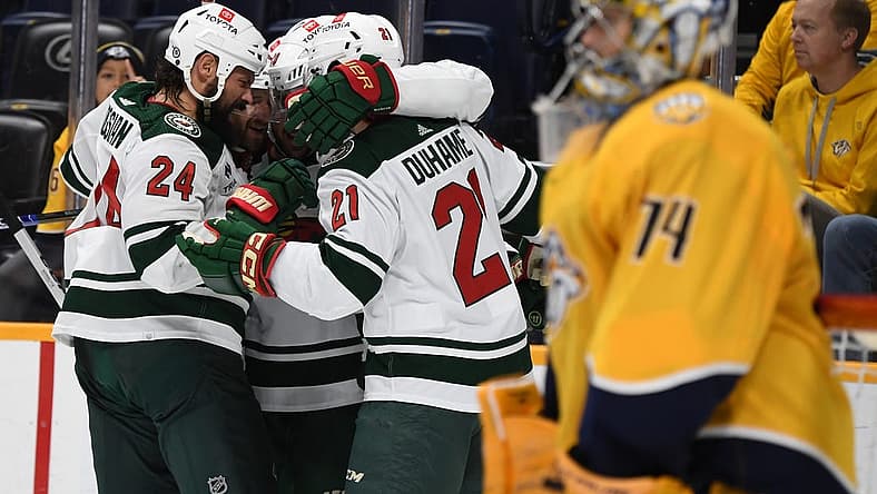 Nov 30, 2023; Nashville, Tennessee, USA; Minnesota Wild players celebrate after a goal by left wing Pat Maroon (20) against Nashville Predators goaltender Juuse Saros (74) during the second period at Bridgestone Arena. Mandatory Credit: Christopher Hanewinckel-USA TODAY Sports