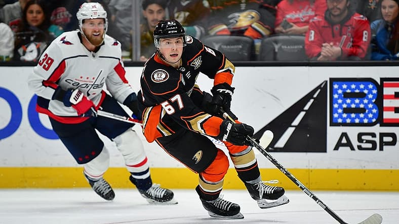 Nov 30, 2023; Anaheim, California, USA; Anaheim Ducks defenseman Tristan Luneau (67) moves the puck ahead of Washington Capitals right wing Anthony Mantha (39) during the third period at Honda Center. Mandatory Credit: Gary A. Vasquez-USA TODAY Sports