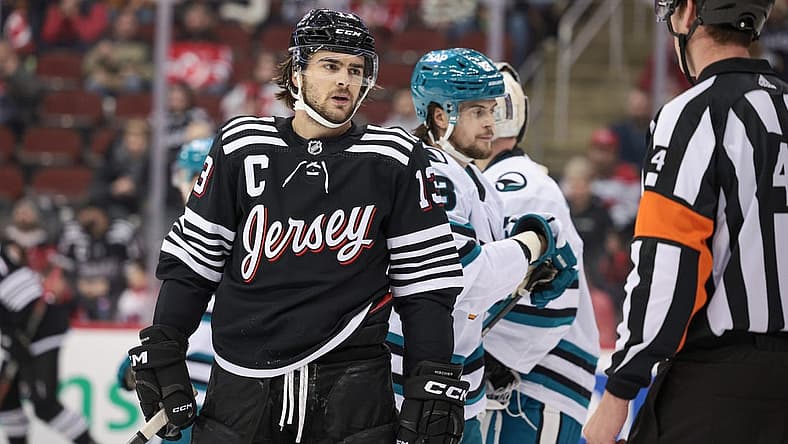 Dec 1, 2023; Newark, New Jersey, USA; New Jersey Devils center Nico Hischier (13) talks with referee Wes McCauley (4) during the first period against the San Jose Sharks at Prudential Center. Mandatory Credit: Vincent Carchietta-USA TODAY Sports