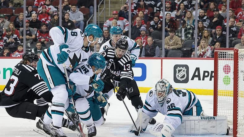 Dec 1, 2023; Newark, New Jersey, USA; San Jose Sharks goaltender Kaapo Kahkonen (36) covers the puck in front of New Jersey Devils center Nico Hischier (13) and right wing Tyler Toffoli (73) as center Tomas Hertl (48) and defenseman Mario Ferraro (38) defend during the first period at Prudential Center. Mandatory Credit: Vincent Carchietta-USA TODAY Sports