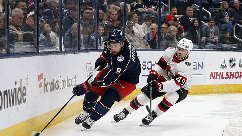 Dec 1, 2023; Columbus, Ohio, USA; Columbus Blue Jackets defenseman Ivan Provorov (9) and Ottawa Senators center Rourke Chartier (49) chase down loose puck during the first period at Nationwide Arena. Mandatory Credit: Russell LaBounty-USA TODAY Sports