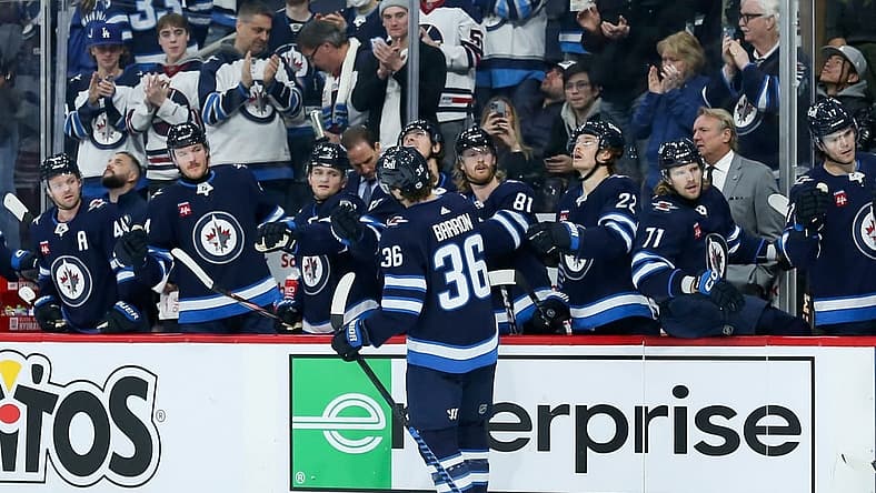 Dec 2, 2023; Winnipeg, Manitoba, CAN; Winnipeg Jets forward Morgan Barron (36) is congratulated by his team mates on his goal against the Chicago Blackhawks during the second period at Canada Life Centre. Mandatory Credit: Terrence Lee-USA TODAY Sports
