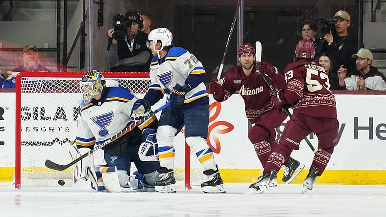 Dec 2, 2023; Tempe, Arizona, USA; Arizona Coyotes left wing Michael Carcone (53) scores against St. Louis Blues goaltender Joel Hofer (30) during the first period at Mullett Arena. Mandatory Credit: Joe Camporeale-USA TODAY Sports