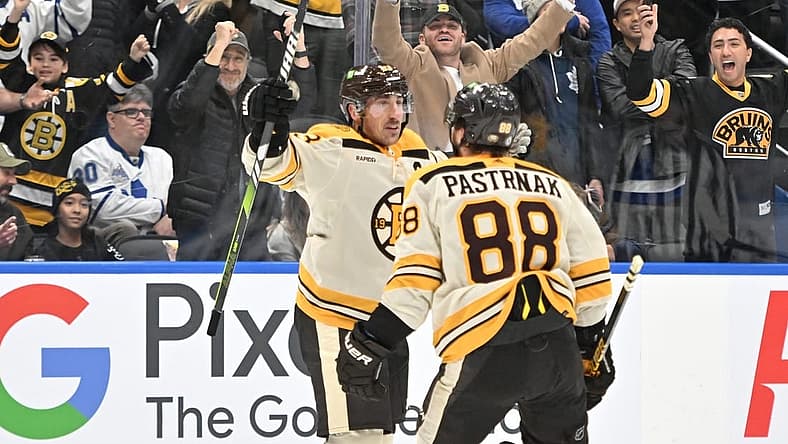 Dec 2, 2023; Toronto, Ontario, CAN; Boston Bruins forward Brad Marchand (63) celebrates with forward David Pastrnak (88) after scoring the game winning goal in overtime against the Toronto Maple Leafs at Scotiabank Arena. Mandatory Credit: Dan Hamilton-USA TODAY Sports