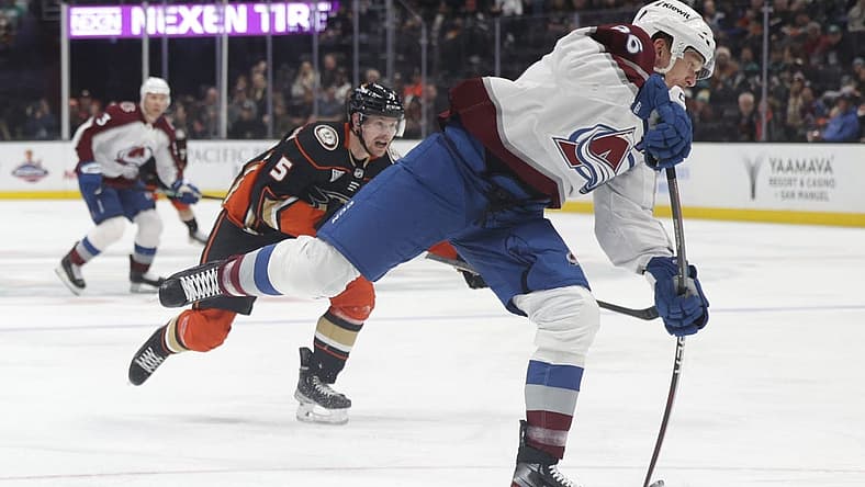 Dec 2, 2023; Anaheim, California, USA; Colorado Avalanche right wing Mikko Rantanen (96) attempts a shot as Anaheim Ducks defensemen Urho Vaakanainen (5) pursues during the first period at Honda Center. Mandatory Credit: Yannick Peterhans-USA TODAY Sports