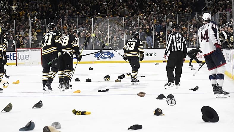 Dec 3, 2023; Boston, Massachusetts, USA; Boston Bruins left wing Brad Marchand (63) celebrates his third goal as fans throw their hats on the ice for his hat trick during the third period against the Columbus Blue Jackets at TD Garden. Mandatory Credit: Bob DeChiara-USA TODAY Sports