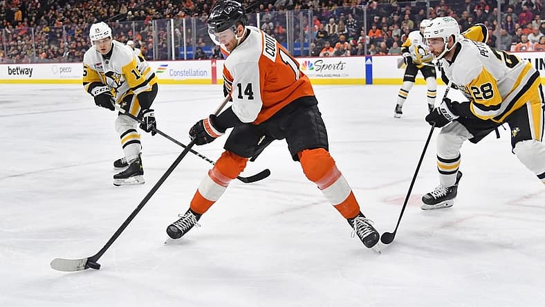 Dec 4, 2023; Philadelphia, Pennsylvania, USA; Philadelphia Flyers center Sean Couturier (14) controls the puck against Pittsburgh Penguins left wing Joona Koppanen (15) and defenseman Marcus Pettersson (28) during the first period at Wells Fargo Center. Mandatory Credit: Eric Hartline-USA TODAY Sports