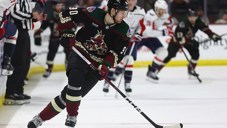 Dec 4, 2023; Tempe, Arizona, USA; Arizona Coyotes defenseman J.J. Moser (90) moves the puck against the Washington Capitals in the third period at Mullett Arena. Mandatory Credit: Mark J. Rebilas-USA TODAY Sports