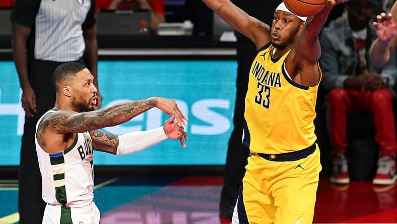 Dec 7, 2023; Las Vegas, Nevada, USA; Indiana Pacers center Myles Turner (33) gets a hand on a pass by Milwaukee Bucks guard Damian Lillard (0) during the first quarter at T-Mobile Arena. Mandatory Credit: Candice Ward-USA TODAY Sports