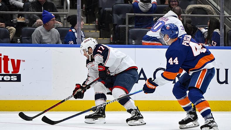 Dec 7, 2023; Elmont, New York, USA; Columbus Blue Jackets right wing Justin Danforth (17) skates past New York Islanders center Jean-Gabriel Pageau (44) during the first period at UBS Arena. Mandatory Credit: John Jones-USA TODAY Sports